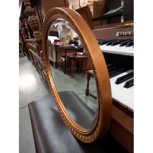 107 - A vintage oval gilt framed bevel edged mirror COLLECT ONLY