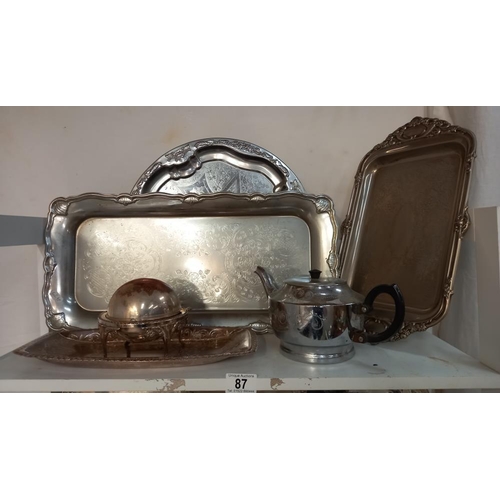 87 - A varied selection of silver plated and chrome metalware on 3 shelves