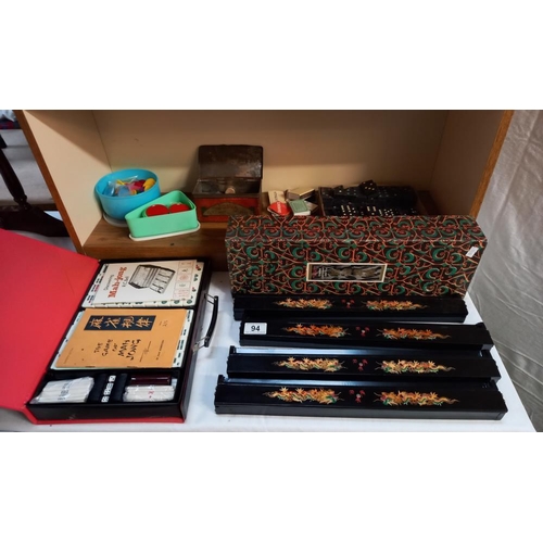 94 - A vintage Mahjong set and various counters, dominoes & a games table etc. (games table missing 1 dra... 