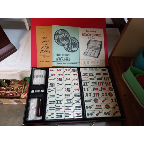 94 - A vintage Mahjong set and various counters, dominoes & a games table etc. (games table missing 1 dra... 