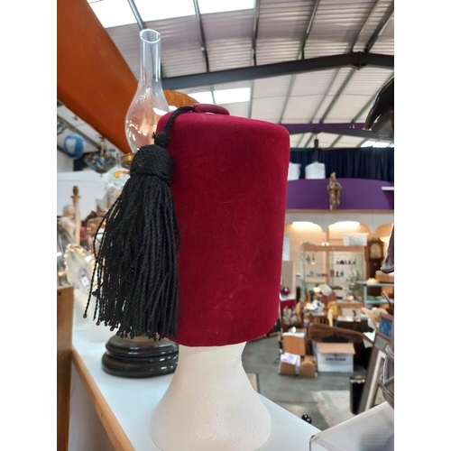 97 - A 1963 Denham and Hargrave Ltd tall Fez, height 22cm, size 7.25