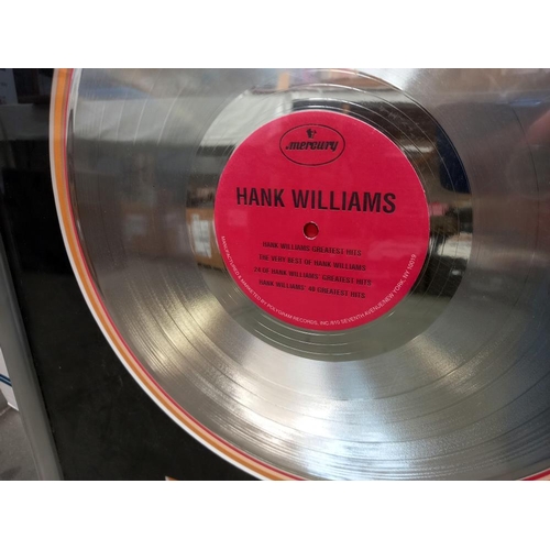 891 - Platinum disc in frame, presented to Sandy Neese for 1000,000 sales of very best of Hank Williams