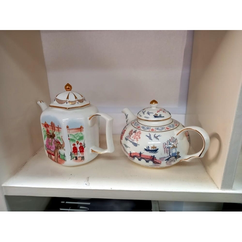 228 - A collection of 6 teapots celebrating the artistry of the earliest teapots, fine bone china for Comp... 