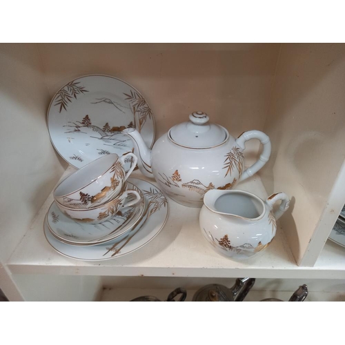 230 - An Oriental china tea set plus two trios and a teapot