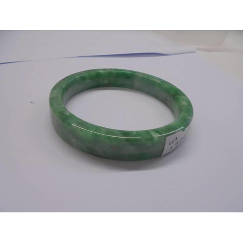 1167 - A jade bangle and a bakelite bangle.