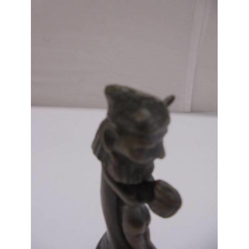 1168 - A small bronze art deco style lady holding Phallic symbol with loose bronze head of the devil.