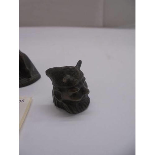 1168 - A small bronze art deco style lady holding Phallic symbol with loose bronze head of the devil.