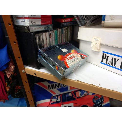 513 - A shelf of assorted CD's and cassette tapes.