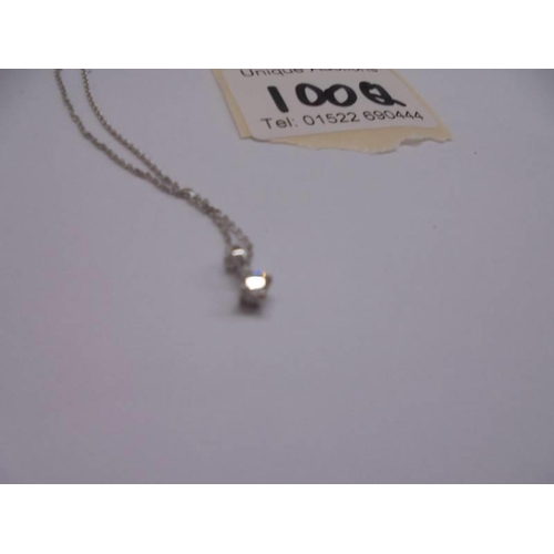 1100Q - A diamond set pendant and chain in white gold, (matching lot 100P).