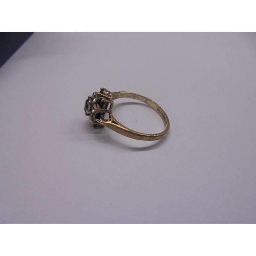 1100U - A green/white stone ring dated Birmingham 1994 in 9ct gold, sixe L half, 1.9 grams.