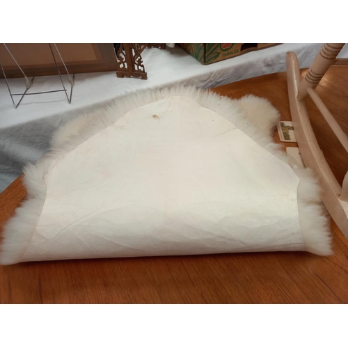 247 - A sheepskin rug 94cm x 60cm at widest parts