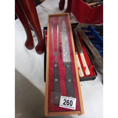 260 - A Le Creuset carving knife and fork set and quantity of other cutlery