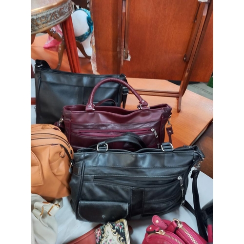 305 - A good selection of ladies modern and vintage handbags, umbrellas, scarf, purse etc