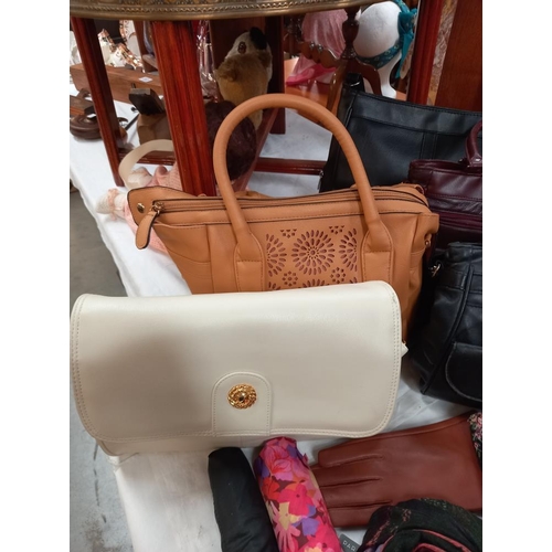 305 - A good selection of ladies modern and vintage handbags, umbrellas, scarf, purse etc