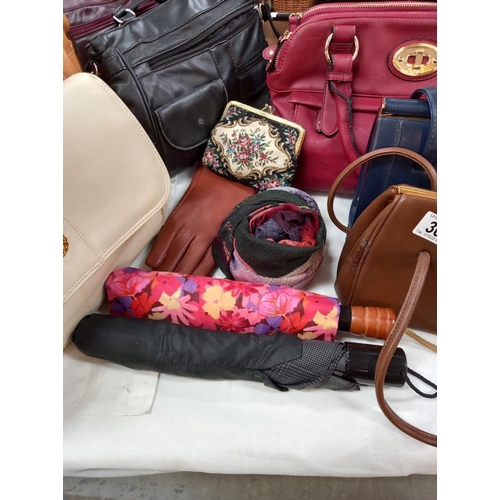 305 - A good selection of ladies modern and vintage handbags, umbrellas, scarf, purse etc