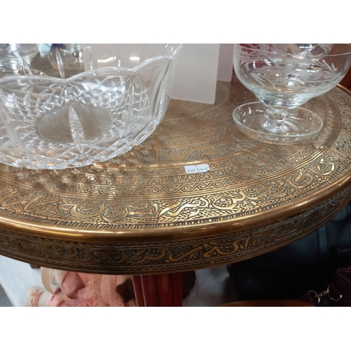 309 - A folding Indian brass topped table, COLLECT ONLY.