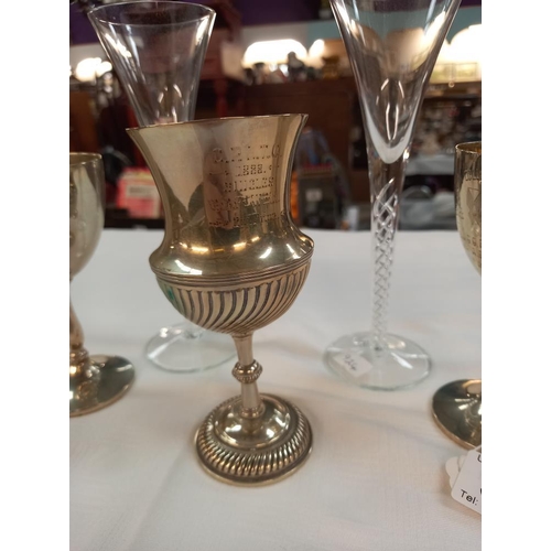 324 - A pair of tall air twist stem glasses and 3 silver plated goblets