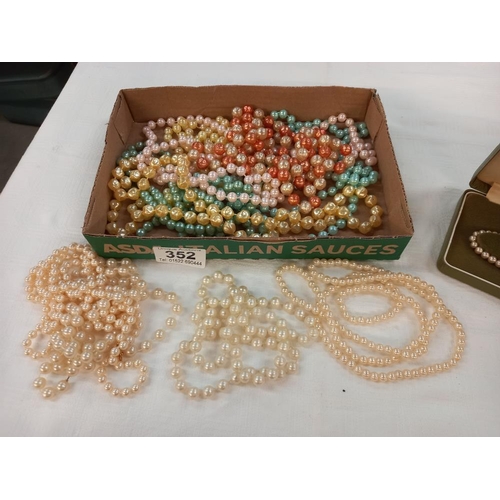 352 - A quantity of bead necklaces and a cased row of pearls