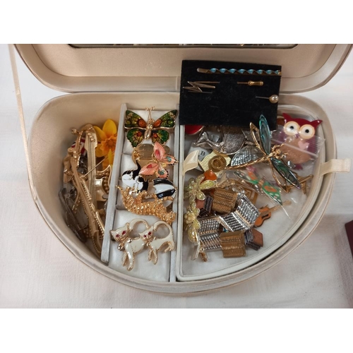 353 - A jewellery box with a mixed lot of brooches and badges