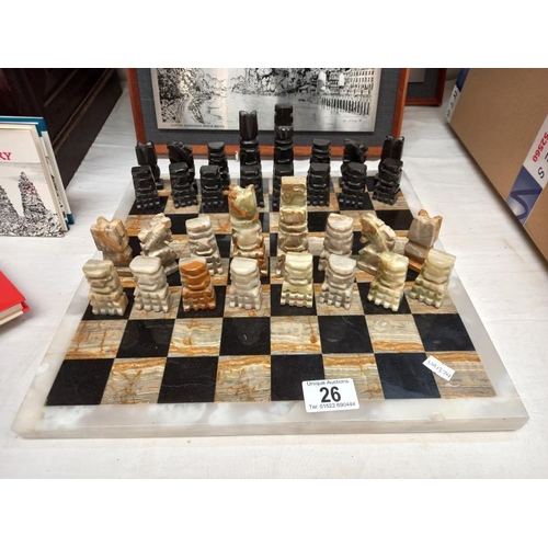 26 - A mixed stone (including onyx) chess board with chess pieces