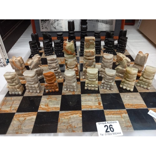 26 - A mixed stone (including onyx) chess board with chess pieces