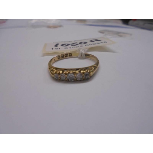 1050A - An 18ct gold ring set with five graduated diamonds, size Q half, 2.8 grams. (Centre diamond approx. ... 