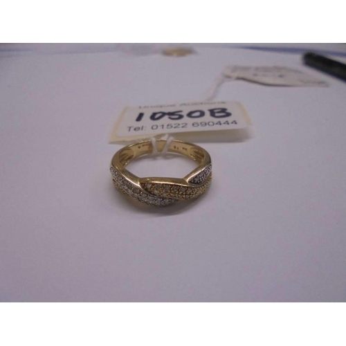 1050B - A 14ct gold double crossover diamond ring, size R, 3.4 grams. (diamaond approx. 0.25cts).