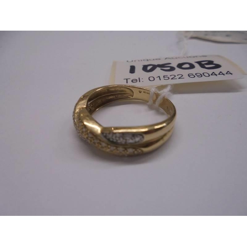 1050B - A 14ct gold double crossover diamond ring, size R, 3.4 grams. (diamaond approx. 0.25cts).