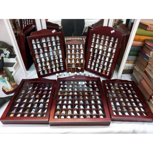 69 - a large collection of thimbles in display cases COLLECT ONLY