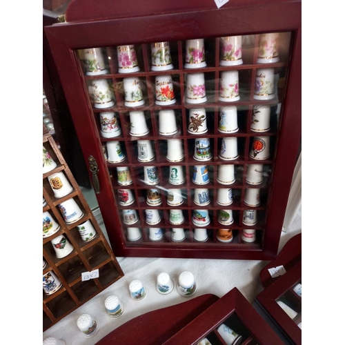 69 - a large collection of thimbles in display cases COLLECT ONLY