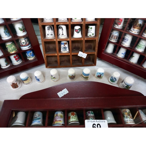 69 - a large collection of thimbles in display cases COLLECT ONLY