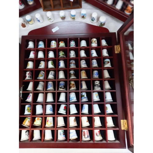 69 - a large collection of thimbles in display cases COLLECT ONLY