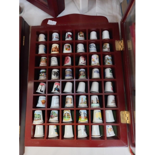 69 - a large collection of thimbles in display cases COLLECT ONLY