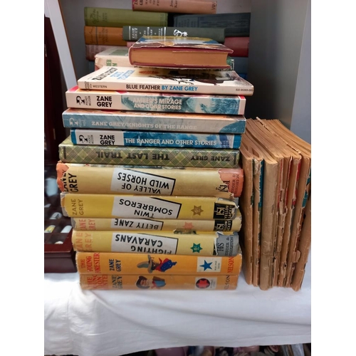 70 - A large quantity of hardback books by Zane Grey, also includes a few paperbacks and some small magaz... 