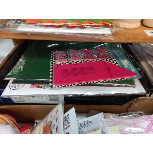 132 - A quantity of sewing and craft items including material, good lot of cutting dies etc