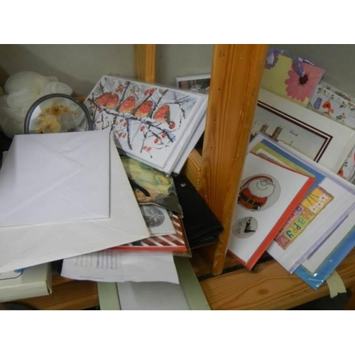 492 - Two shelves of miscellaneous cards, bags etc.,