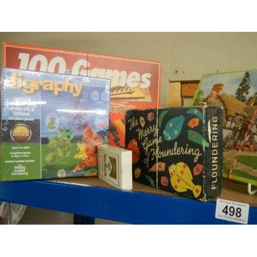 498 - A quantity of jigsaw puzzles etc.,