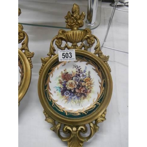 503 - An excellent pair of brass framed china plates.