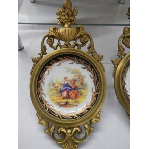 503 - An excellent pair of brass framed china plates.