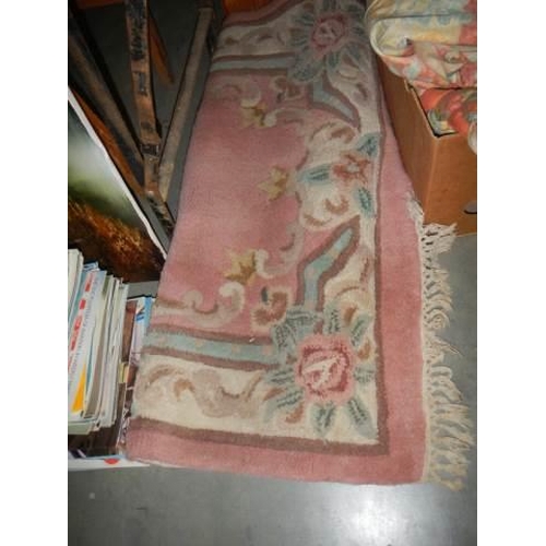 561 - A Chinese pink wool rug, COLLECT ONLY.