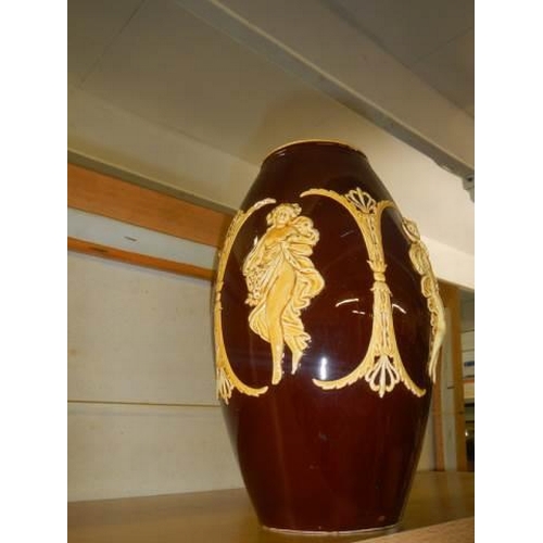 562 - A early 20th century terracotta vase with applied figures.