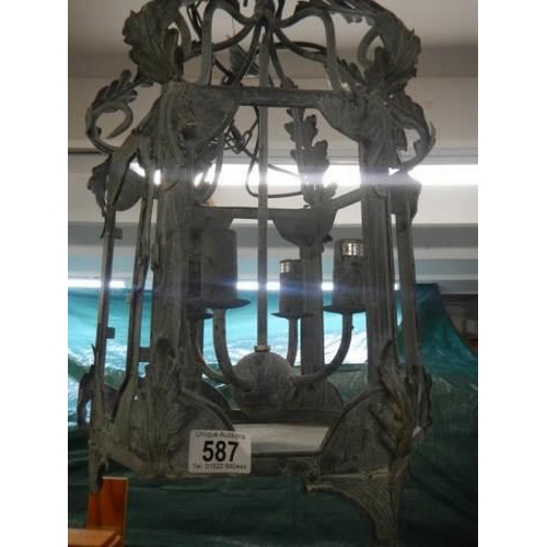 587 - A wrought iron exterior porch lantern.