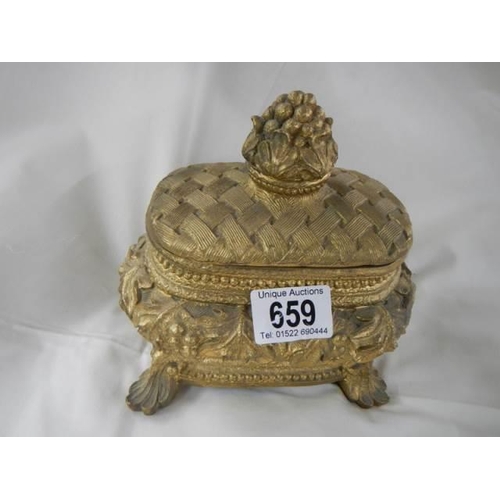 659 - A 20th century gilded trinket box.