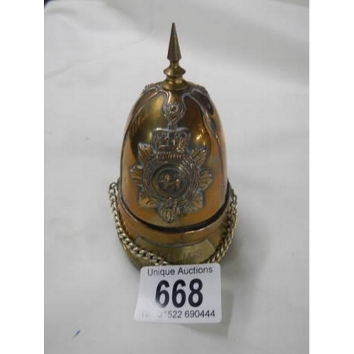 668 - A cigarette lighter in the shape of a helmet.