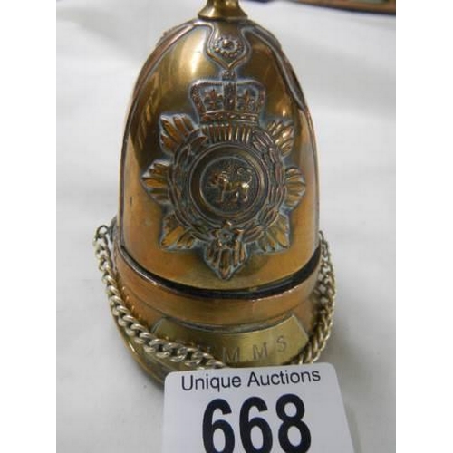 668 - A cigarette lighter in the shape of a helmet.