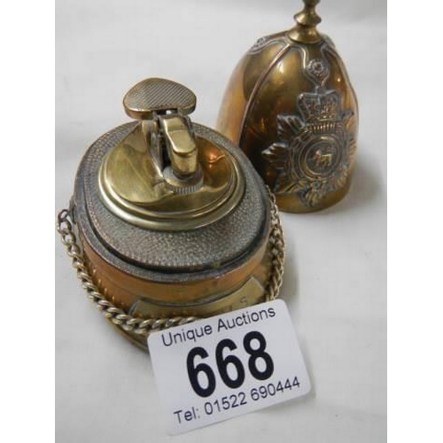 668 - A cigarette lighter in the shape of a helmet.