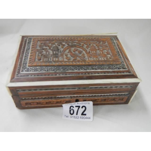 672 - A carved wood box.