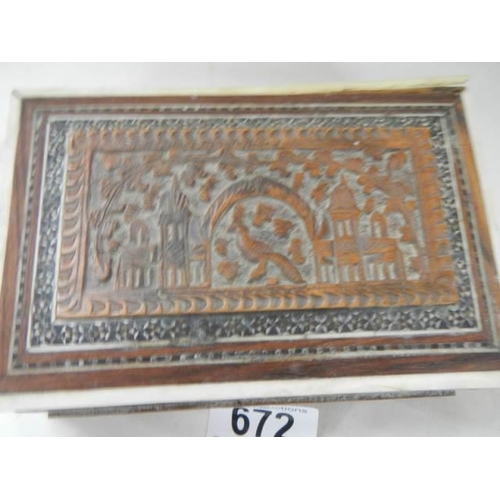 672 - A carved wood box.