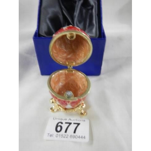 677 - A boxes enamel egg trinket box.