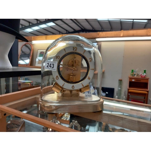 A Junghans magnetic balance wheel clock small chip in glass dome